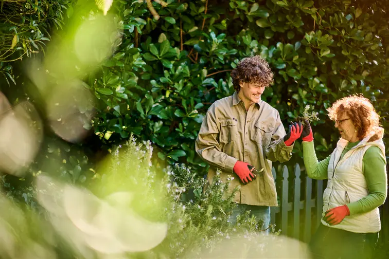 A student and employer working together in a garden