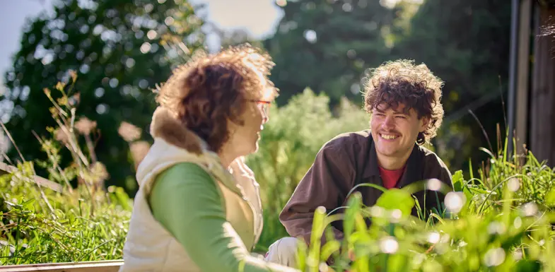 A student and employer working together in a garden